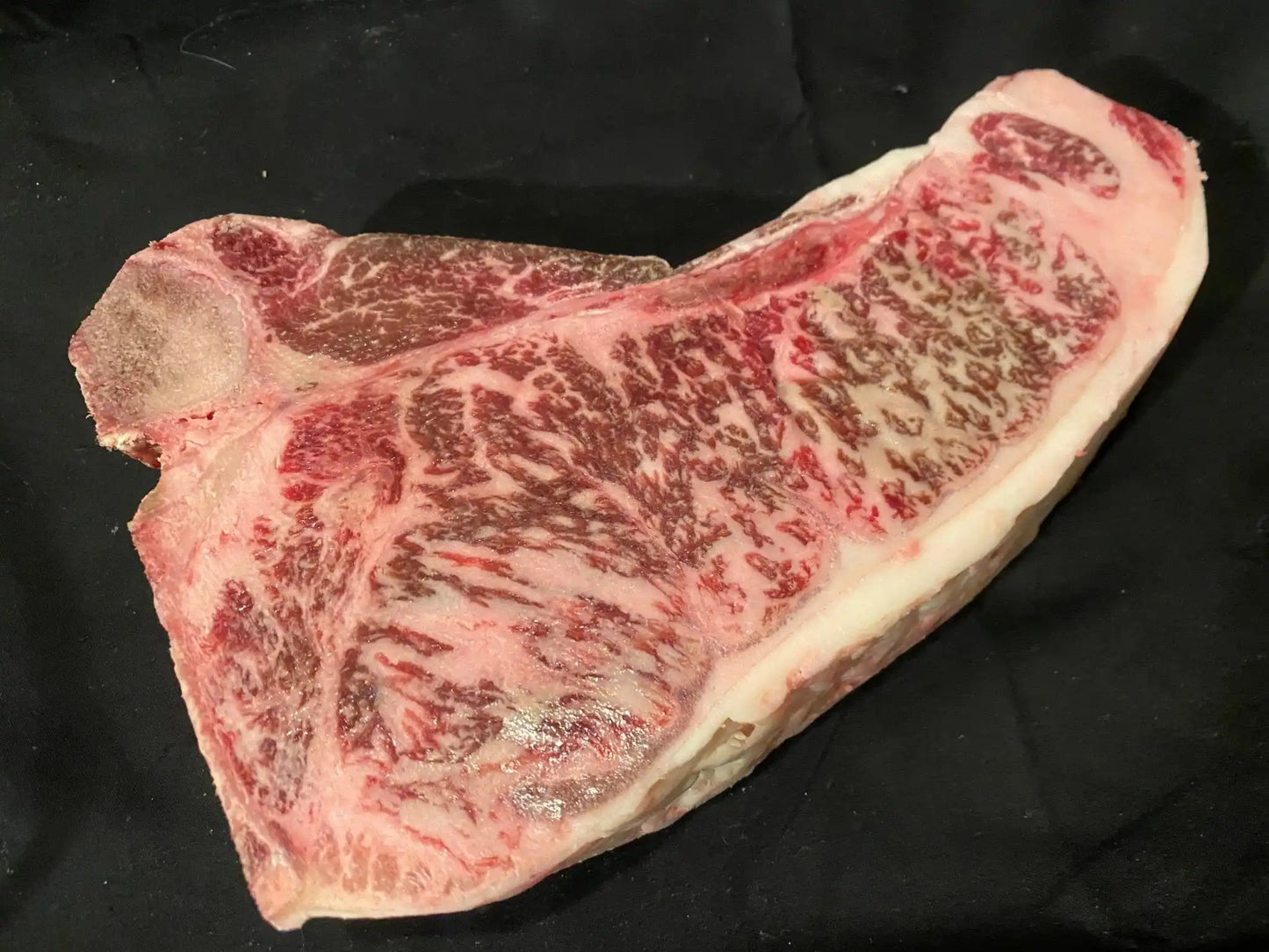 100% All-Natural American Wagyu T-BoneWagyu T-Bone is a prized cut of beef that combines two flavorful and tender sections in one steak—the tenderloin and the strip loin. It is known for its generous mar-Natural American WagyuThe Hufeisen-Ranch (WYO Wagyu)
